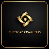 Thetford Computers gold logo centered on a black background